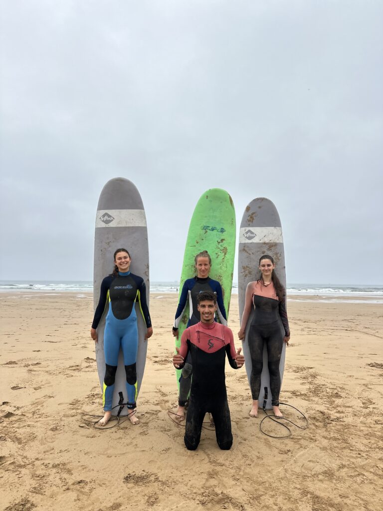 Our surf instructor with two surfers in Tamraght Morocco