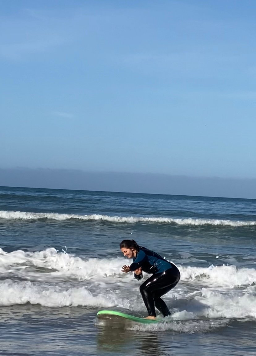 Beginner catching a wave in Tamraght Morocco