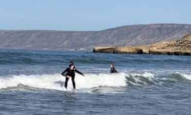 Beginner catching a wave in Tamraght Morocco