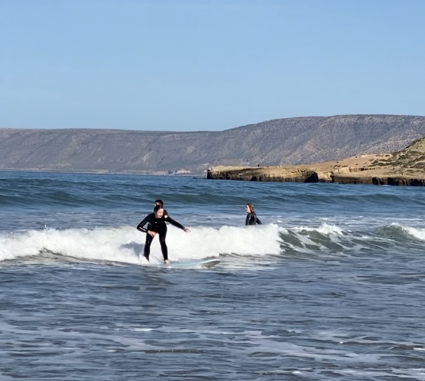 Beginner catching a wave in Tamraght Morocco
