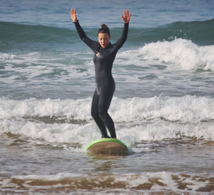 Beginner catching a wave in Tamraght Morocco
