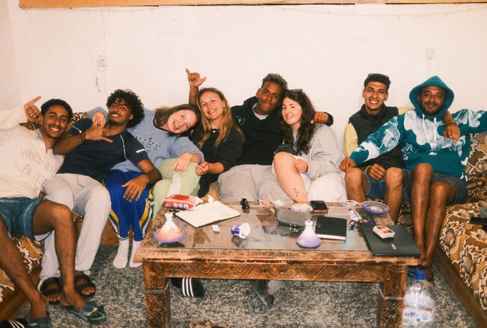 Surf group smiling at Paddle Out Morocco rooftop