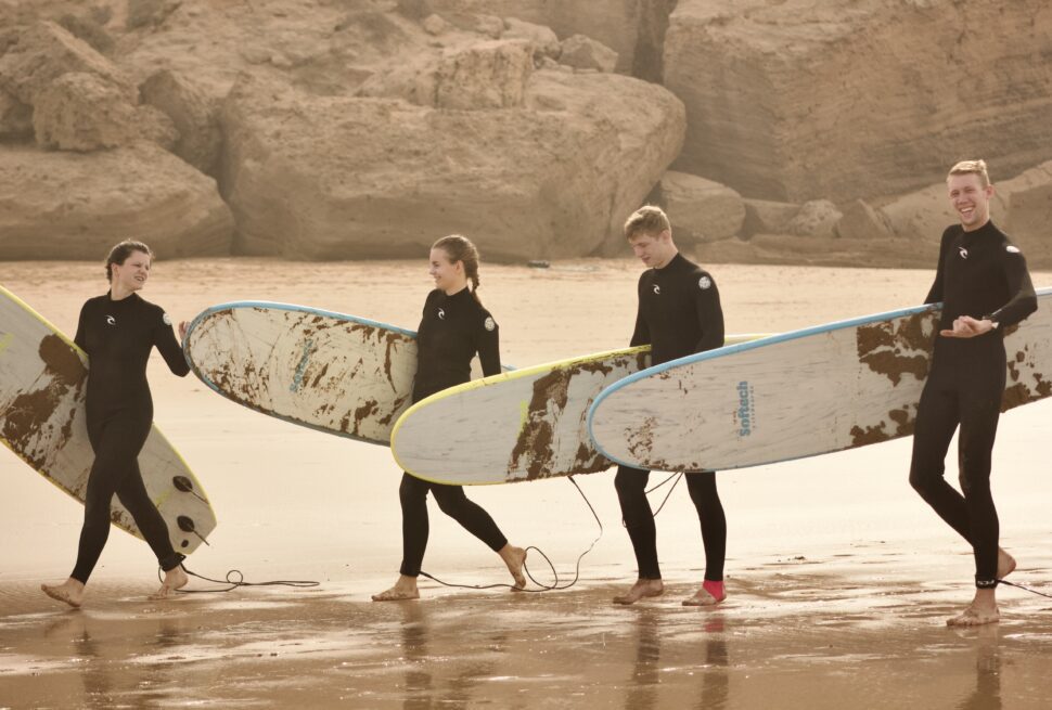 Smiling student learning on best beginner surfboard in Tamraght
