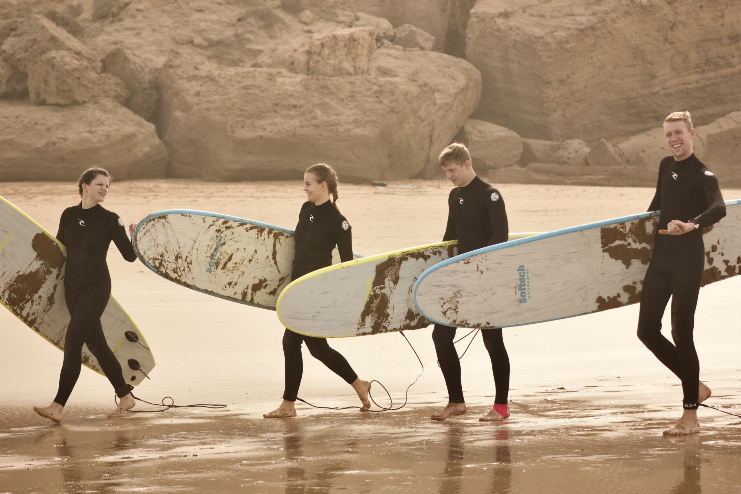 Smiling student learning on best beginner surfboard in Tamraght