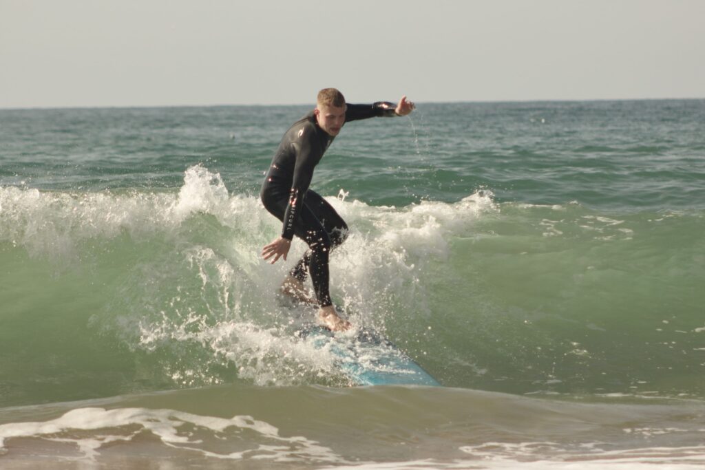 Surf instructor teaching beginner surfers at Tamraght