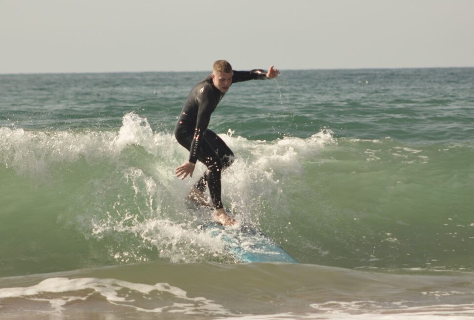 Surf instructor teaching beginner surfers at Tamraght