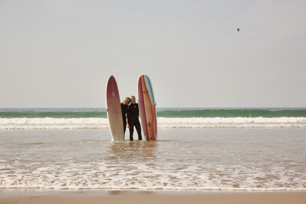 Surfer catching a wave at Tamraght beach, Morocco