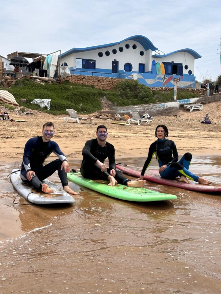 Intermediate surfer paddling during surf lessons in Tamraght for intermediate surfers