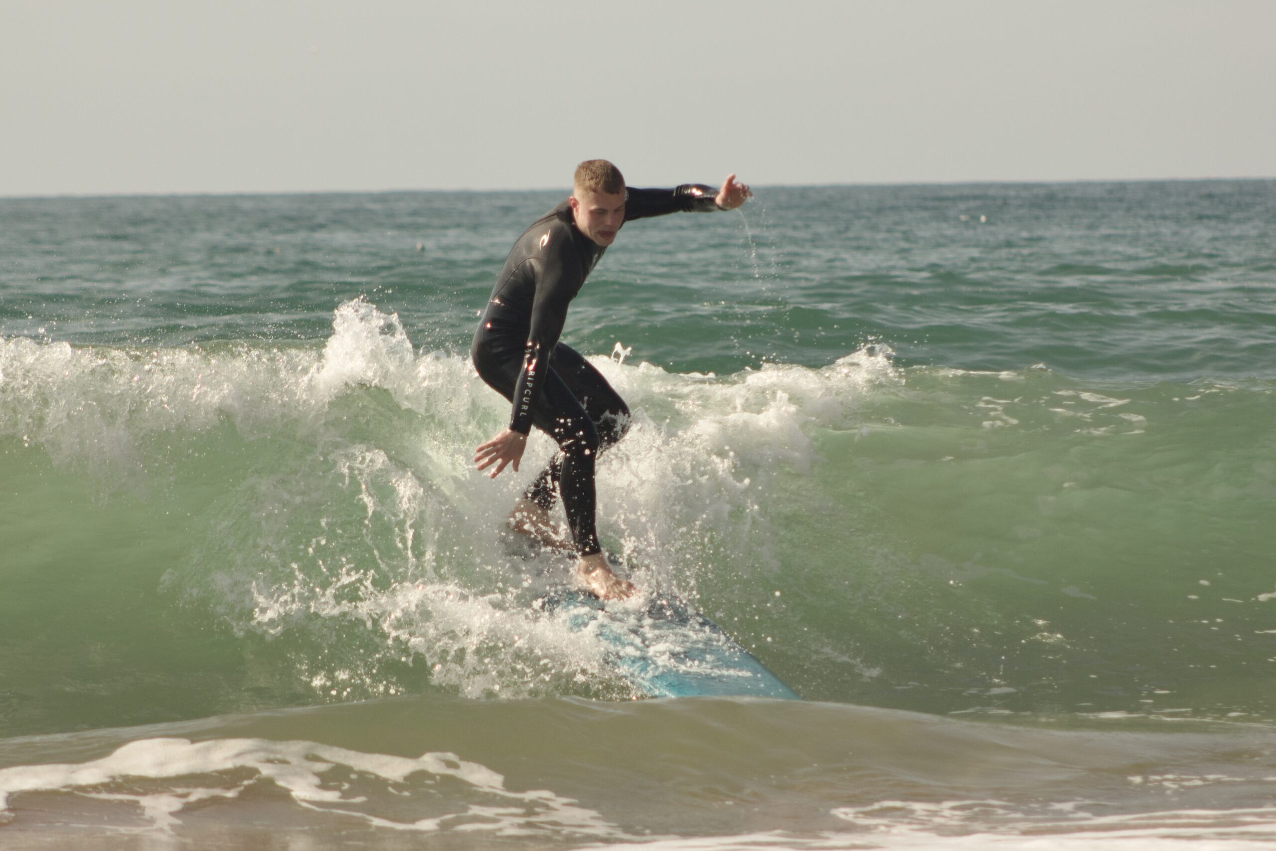 Surfer performing a turn during intermediate surf lessons in Tamraght
