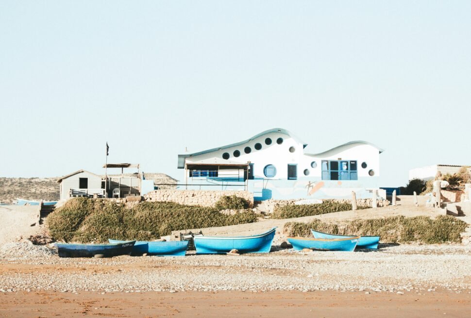 blue boats docked near the seashore