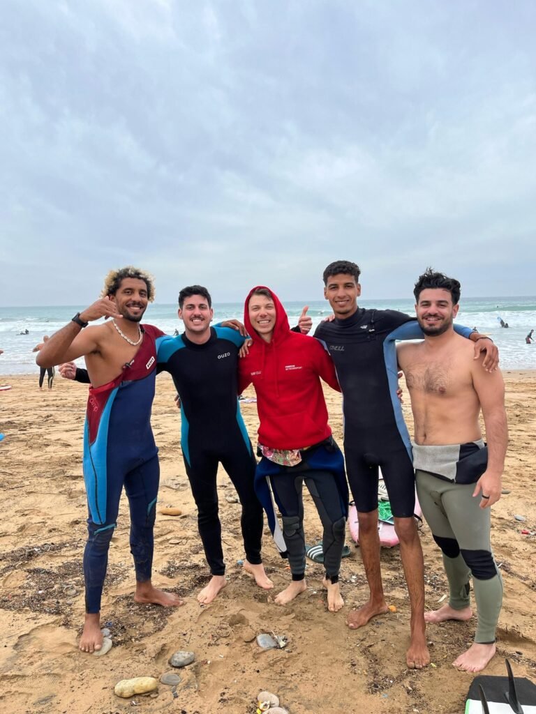 Surf coach with a guest in the water
